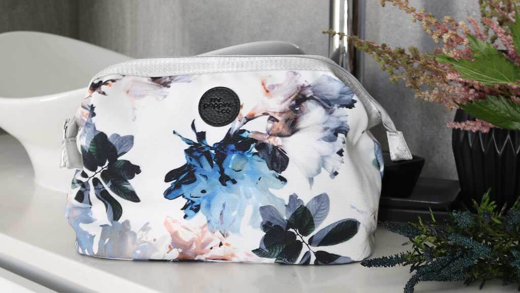 Floral toiletry bag on a luxury bathroom benchtop