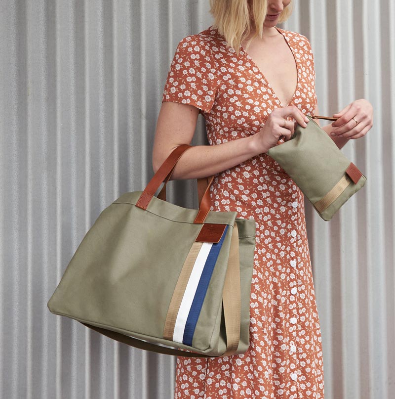 Khaku canvas tote with arm through leather straps and holding seperate purse