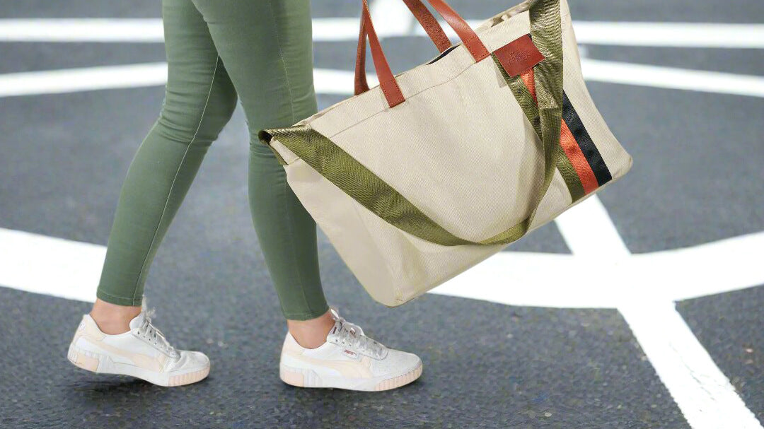 Woman thighs down crossing the road with a beige tote