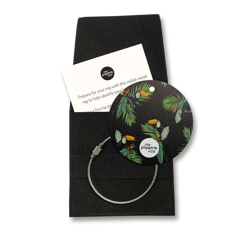 Metal luggage tag in toucan print on a black gifting envelope
