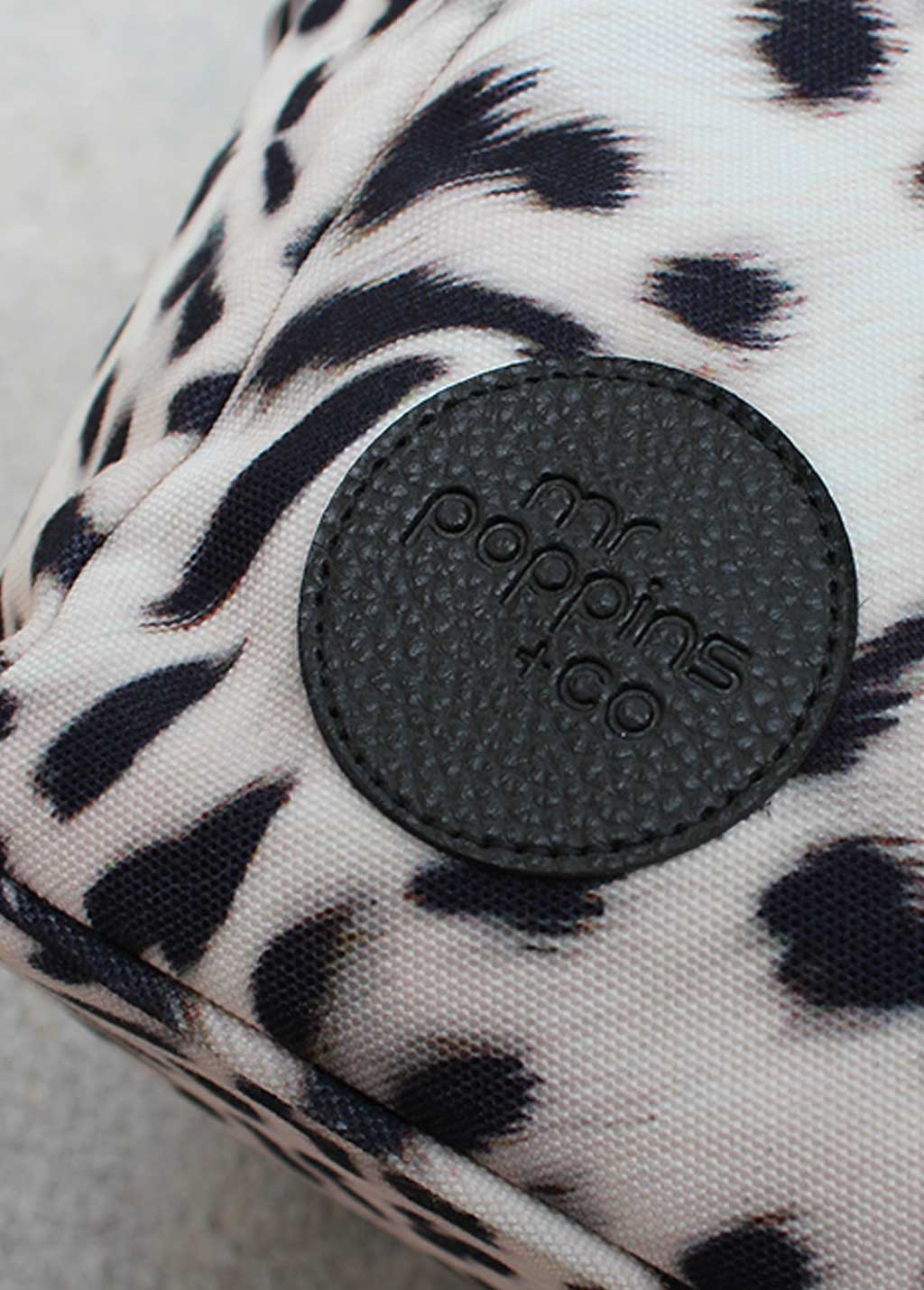  close up on embossed logo of front of Leisure Bag