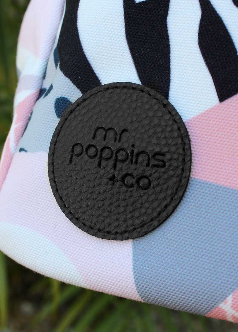 Close up on the embossed logo detail on the Mr Poppins+Co weekender bag