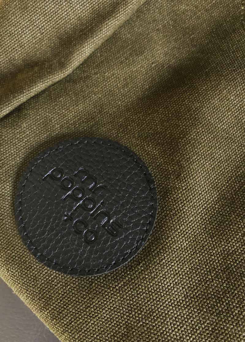 close up on embossed logo of front of Leisure Bag