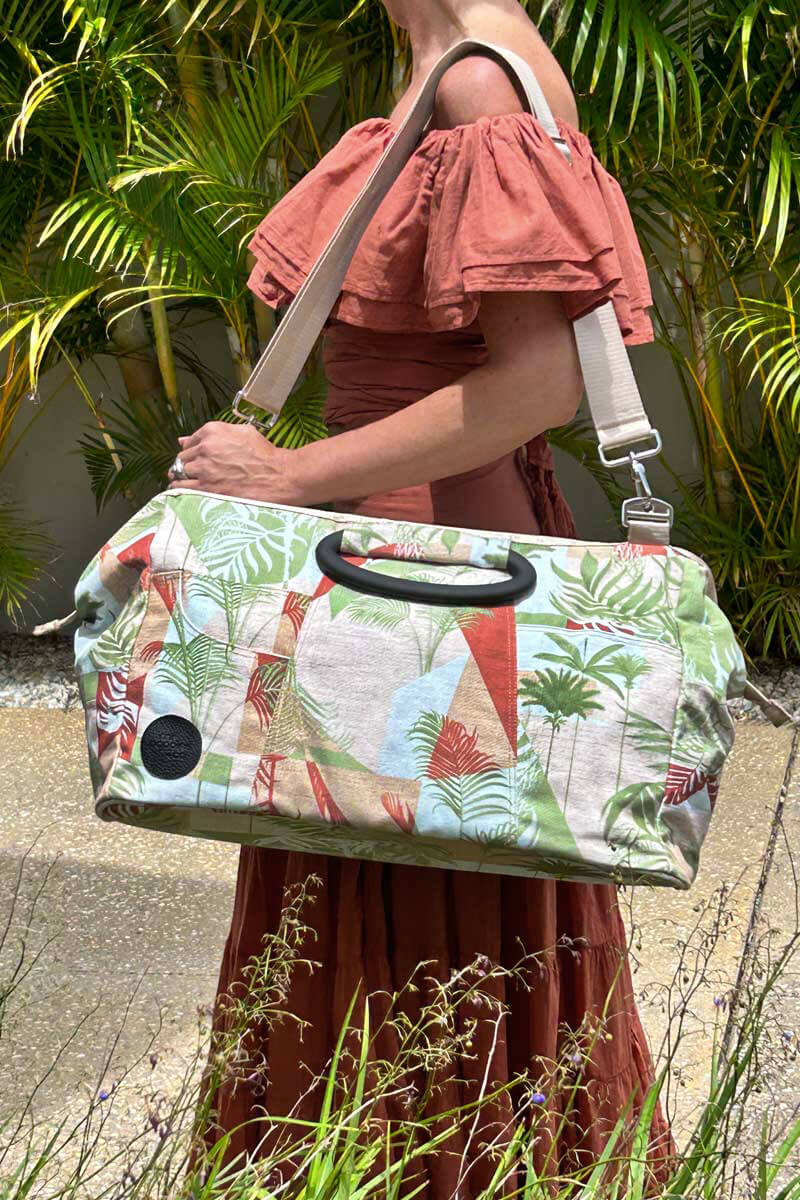 Palm Springs carry-on bag over woman&#39;s shoulder