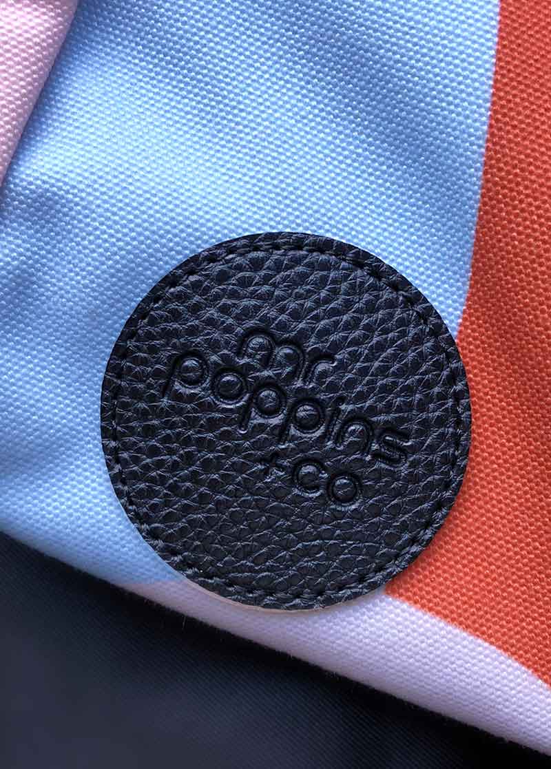 close up on embossed logo of front of Leisure Bag