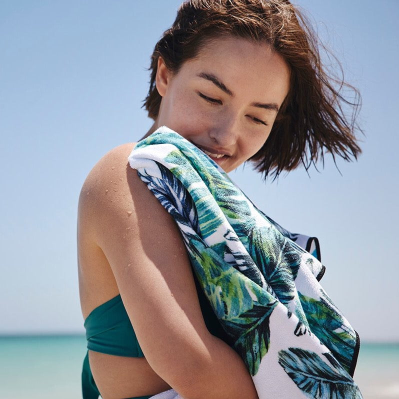 Sand free beach towel in blue and green feather print