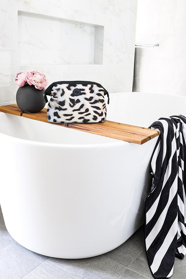 Cheetah toiletry bag in luxury bathroom with striped towel