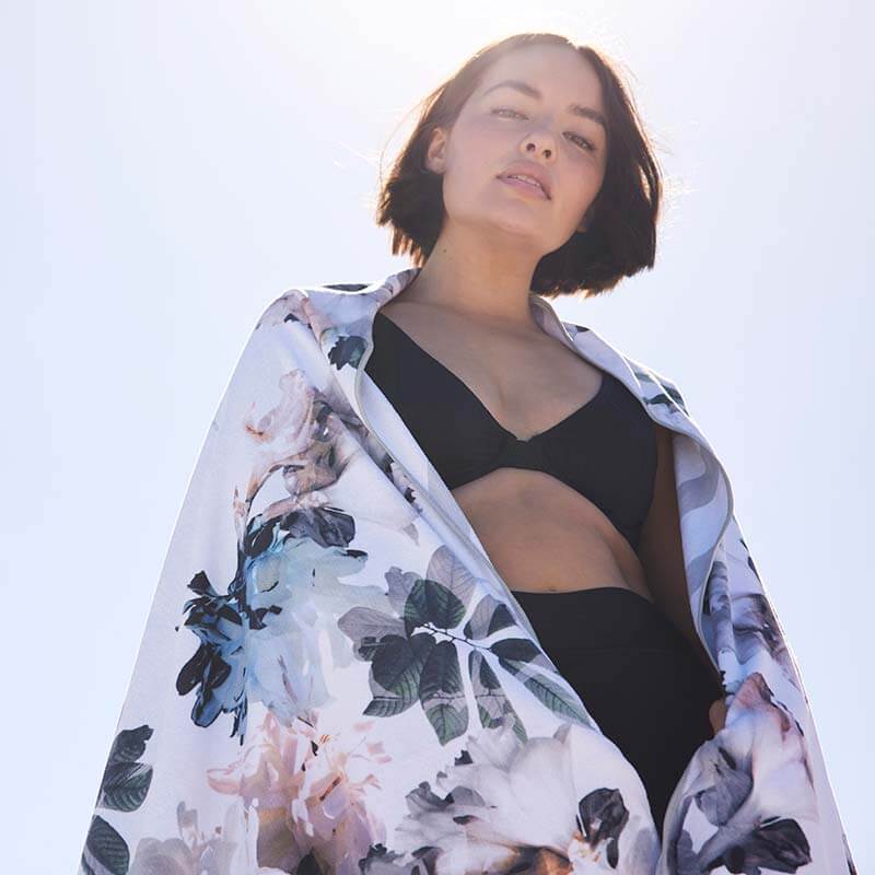 Woman wrapped in a floral sand free Beach towel