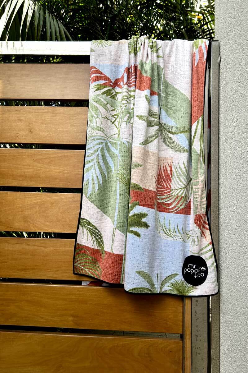 Palm springs towel hanging over a wooden door
