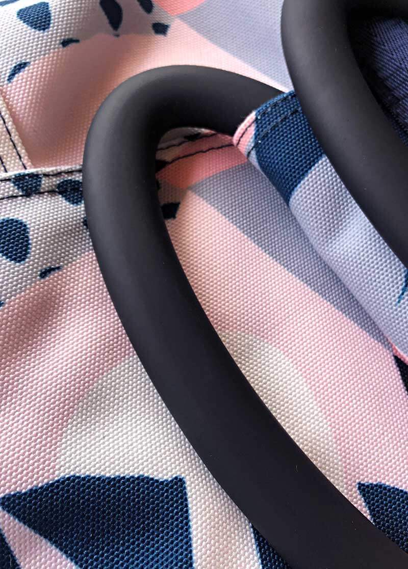 Close up on the smooth handles against an exclusive fabric print